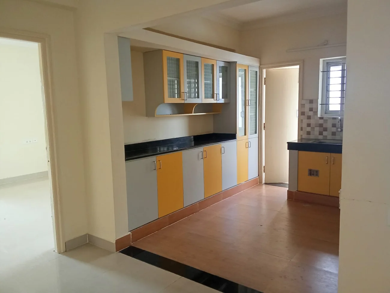 Finished apartment kitchen with fitted wooden cabinetry and countertop