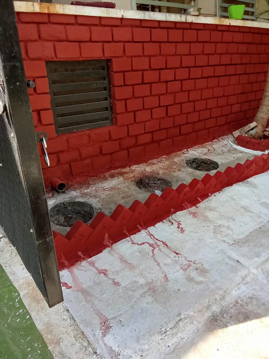 Freshly painted red brick wall with a clean concrete floor