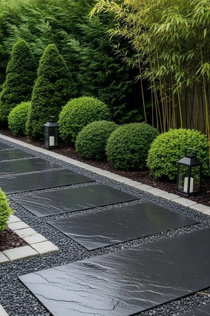 Dark slate tile pathway laid through a landscaped garden